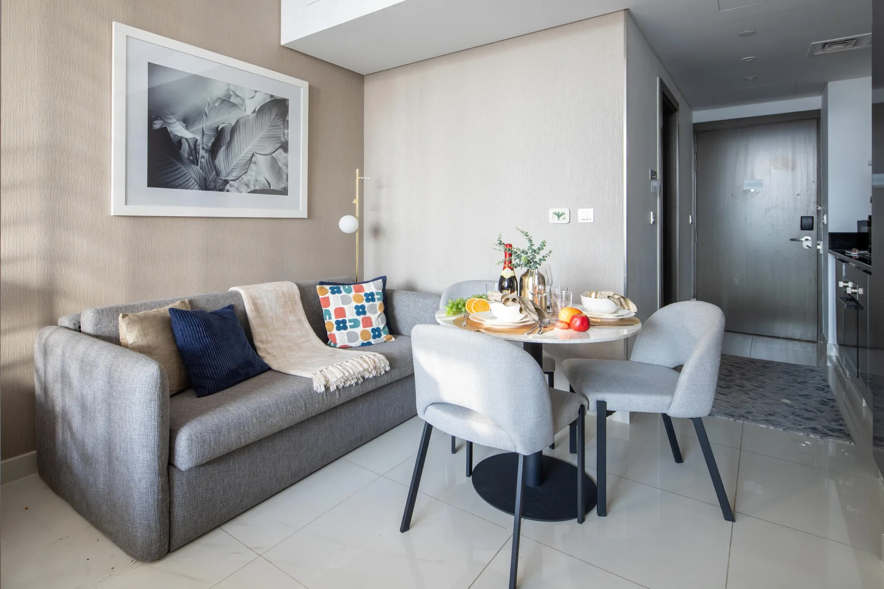 A bright living and dining area with a sofa, table, and chairs.