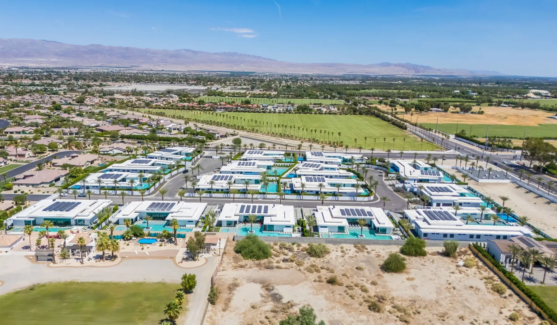 An aerial view of a large campus with low buildings and surrounding fields.