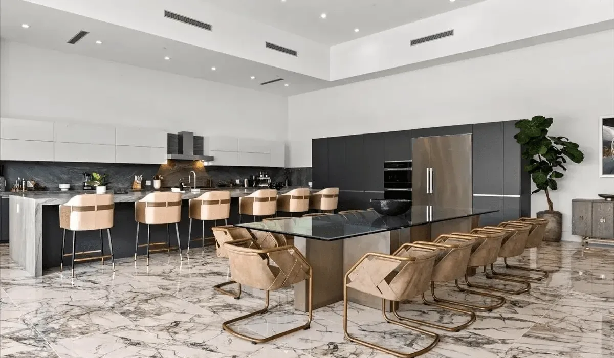 A modern open-plan kitchen and dining area with a long island and seating.