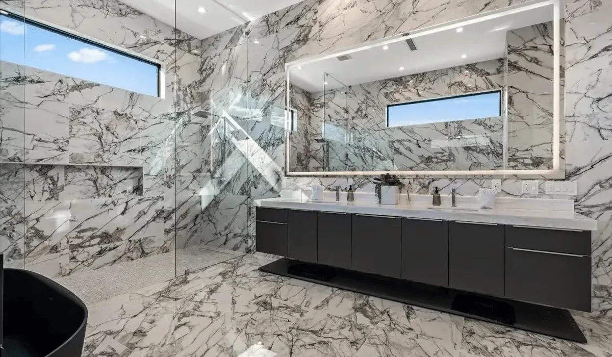 A bathroom with a long vanity and large mirror.