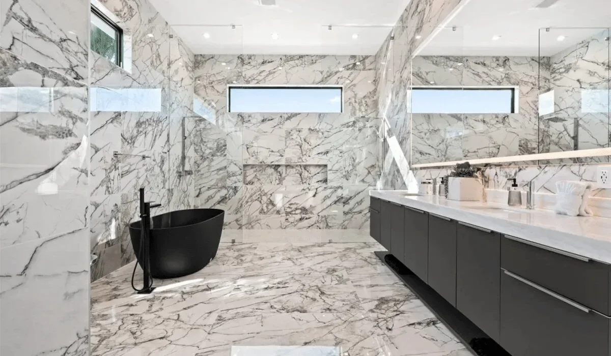 A spacious bathroom with a freestanding bathtub and a long vanity.