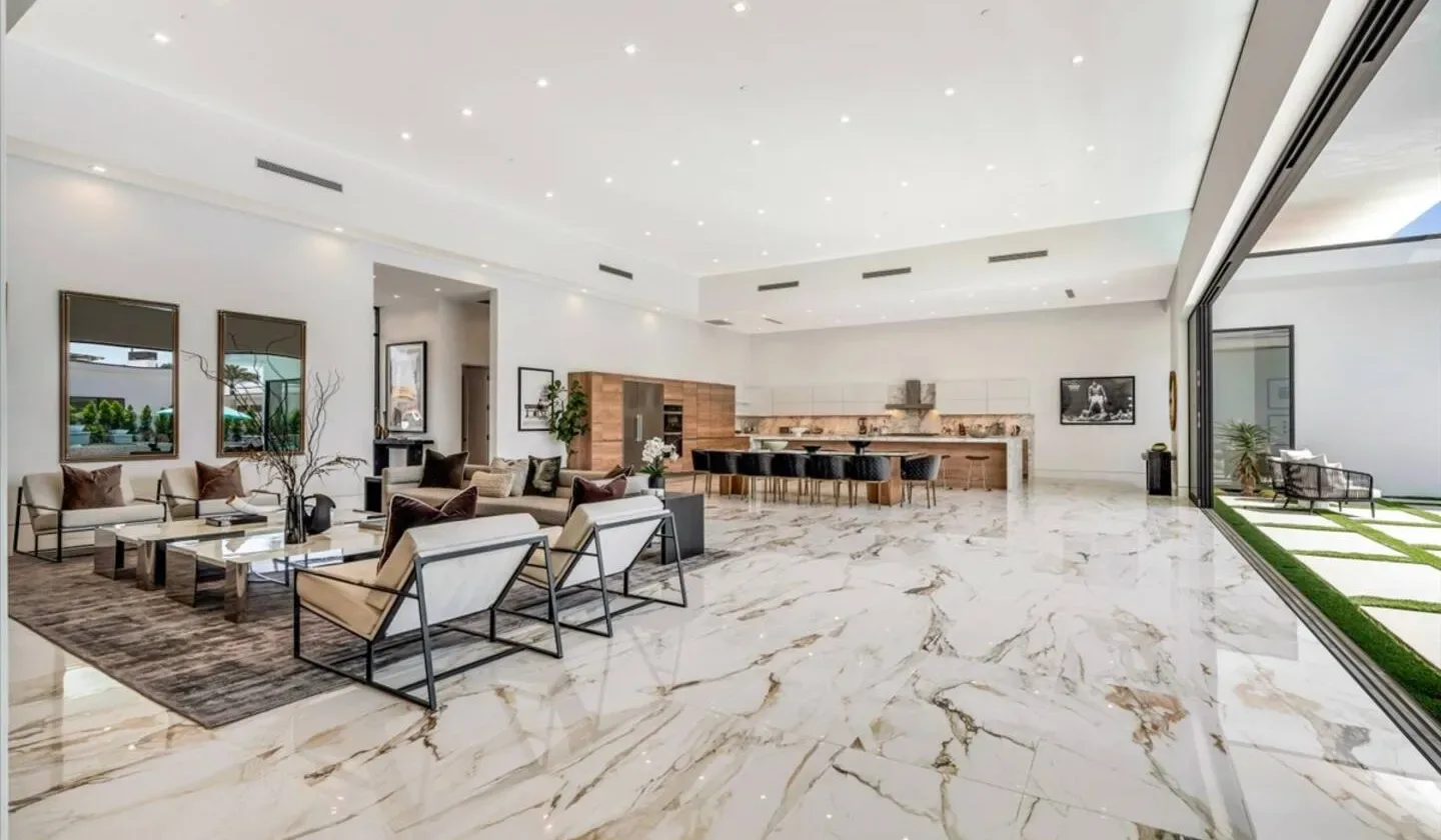 A spacious living area with seating and a long kitchen counter.
