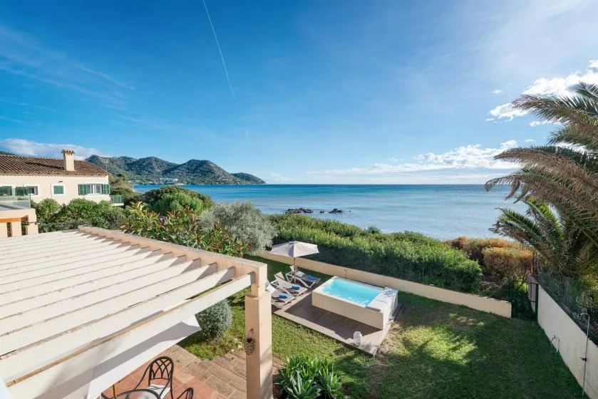 Coastal garden with a swimming pool overlooking the sea.