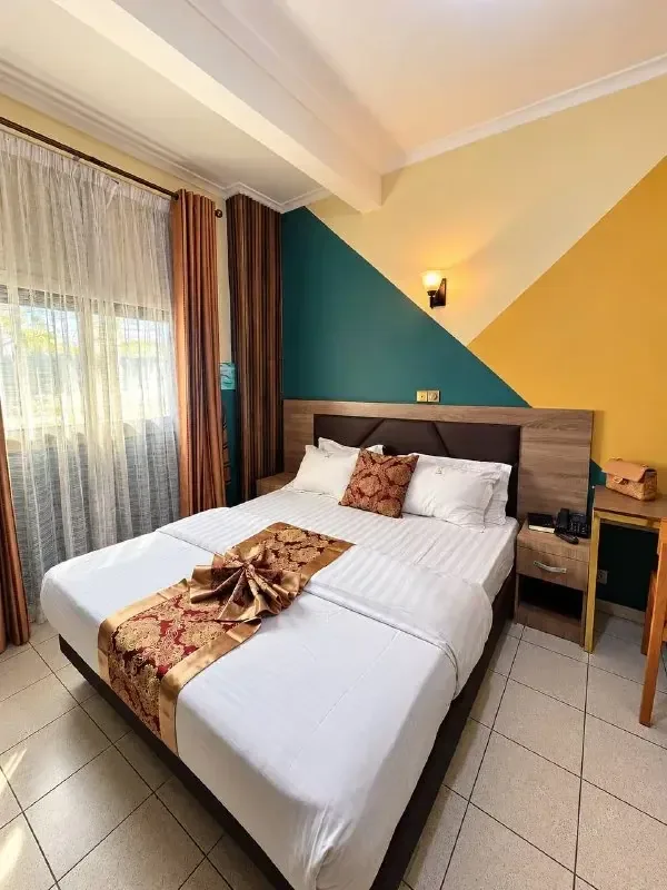 Ultra Confort room with a double bed and large window