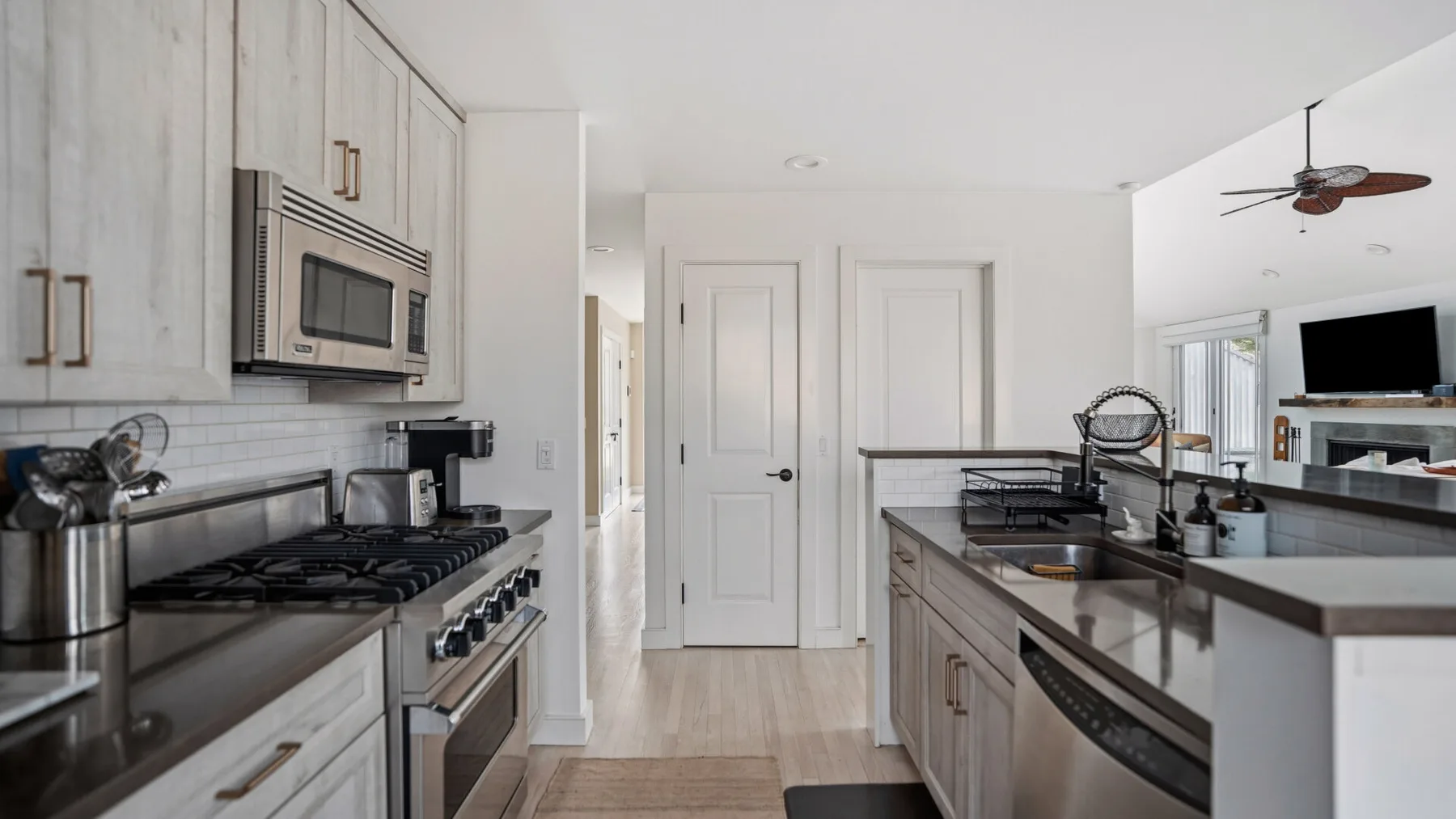 Una cocina luminosa con gabinetes blancos y una isla central.