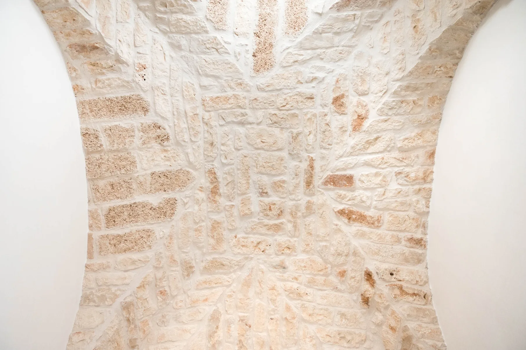 A stone-walled interior with a vaulted ceiling.