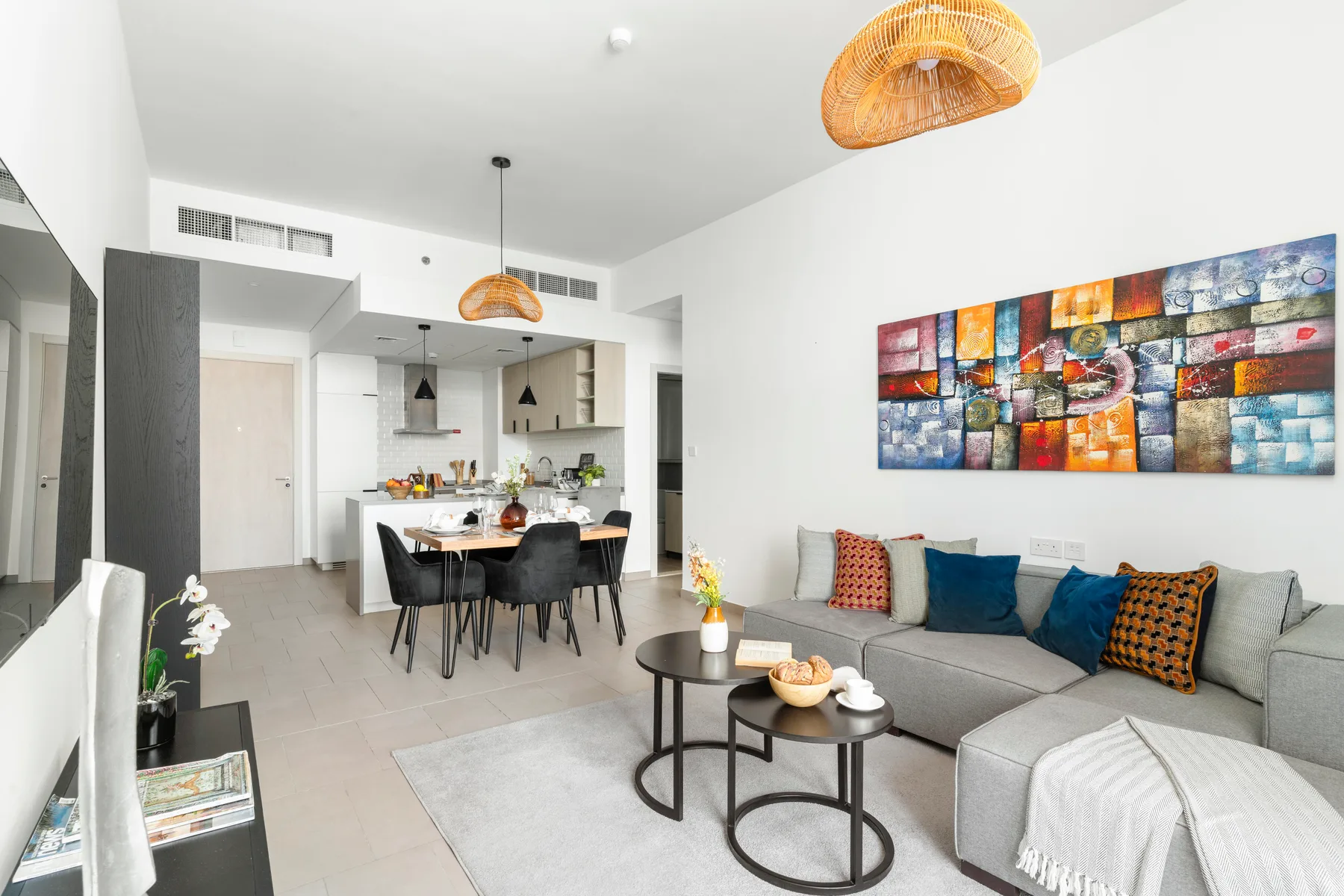 A living and dining area with a sectional sofa and dining table.