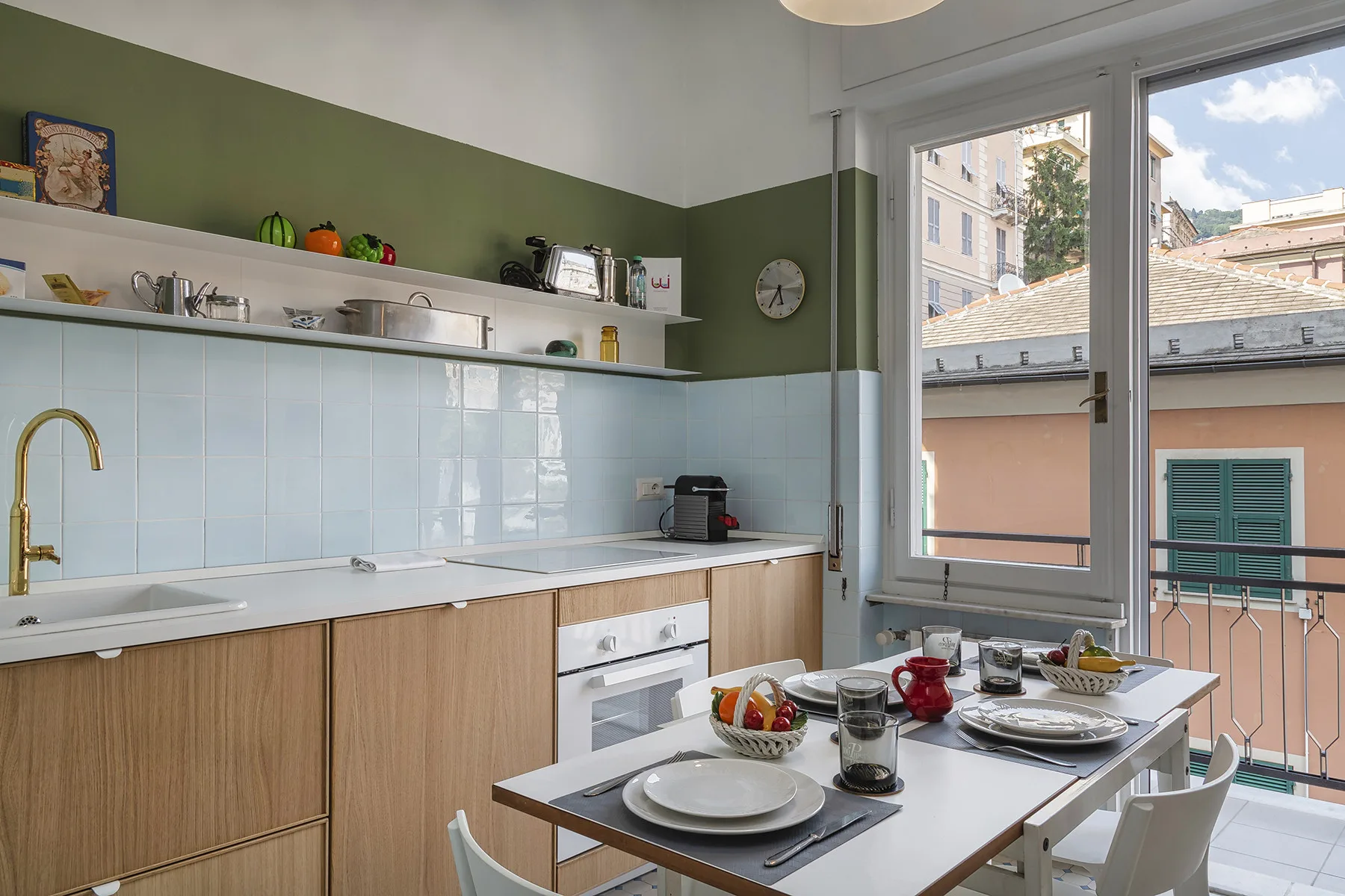 A bright kitchen with a dining table set beside large windows.