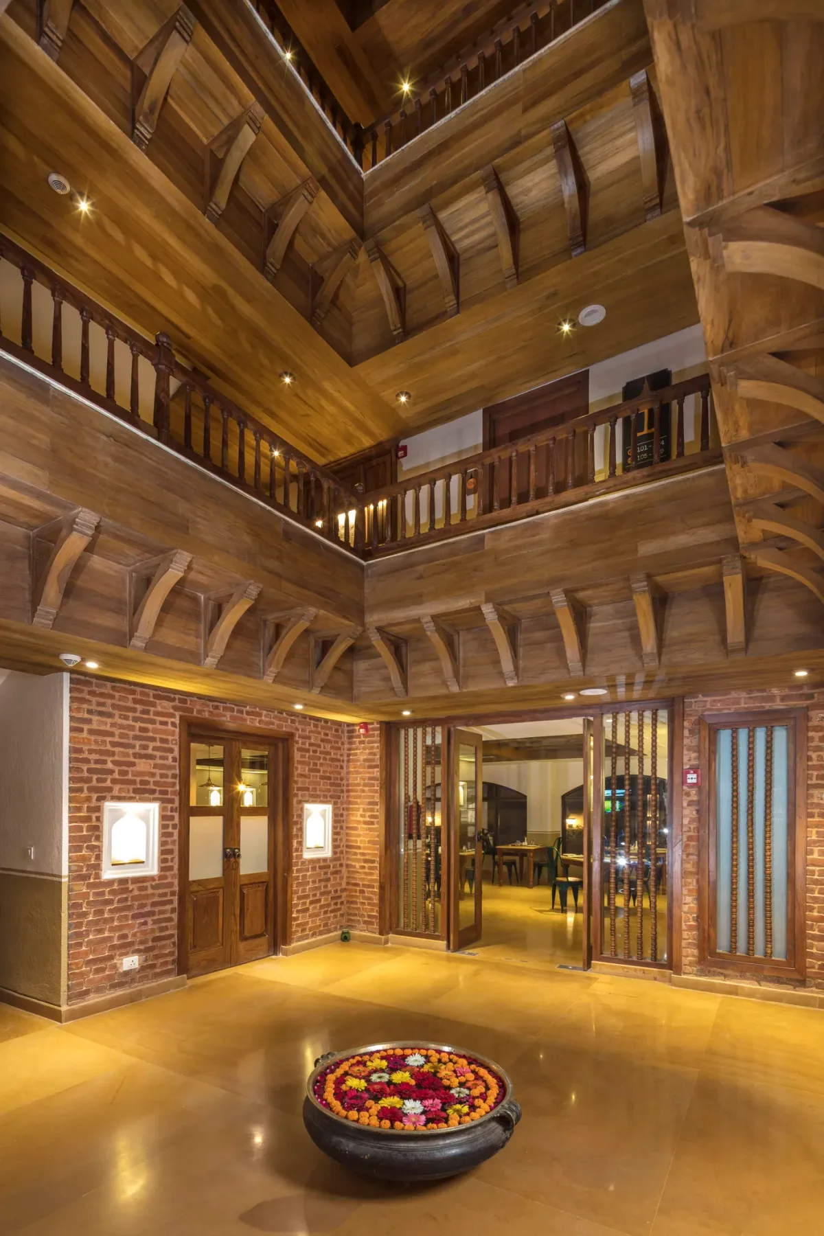 Hand-carved timber hotel lobby with exposed brick walls.