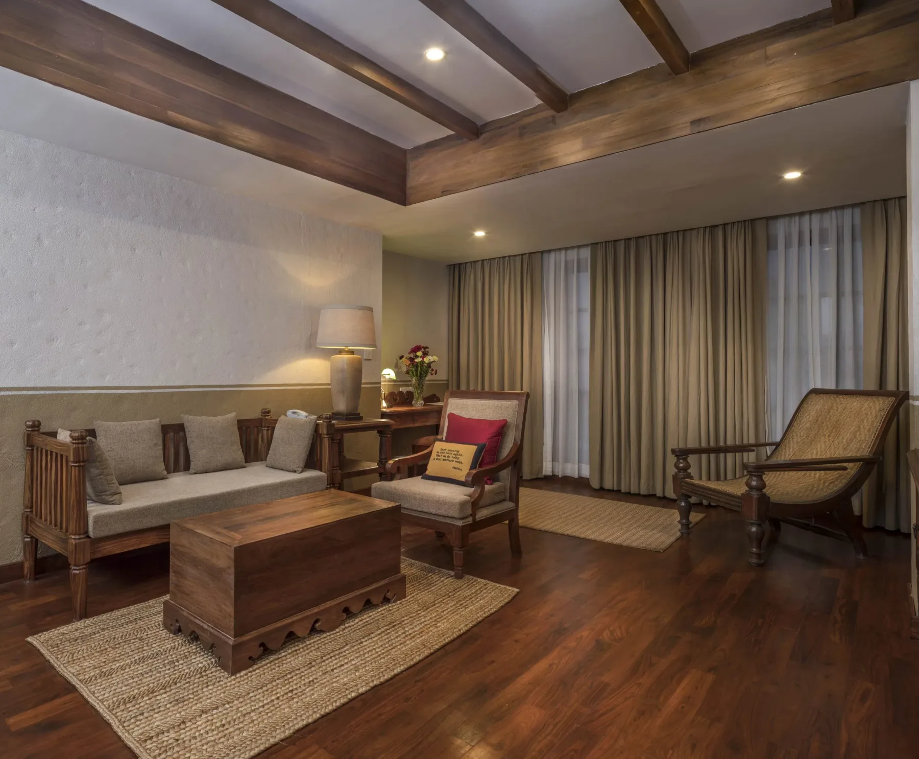Executive Suite living room with a daybed and timber-beamed ceiling.