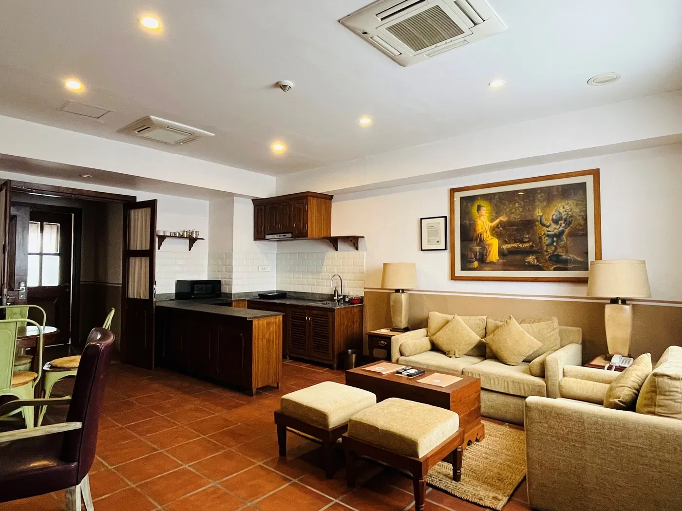 Indragriha Apartment Suite living room with dining area and kitchen beyond.