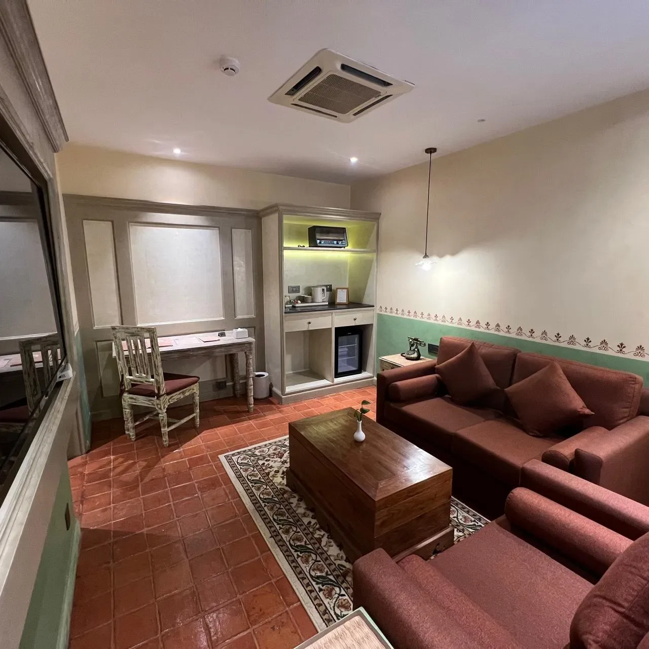 Classic Junior Suite sitting room with sofas and terracotta flooring.