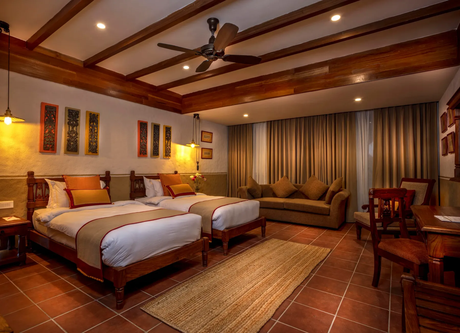 Heritage Deluxe Twin Room with two carved wooden beds.