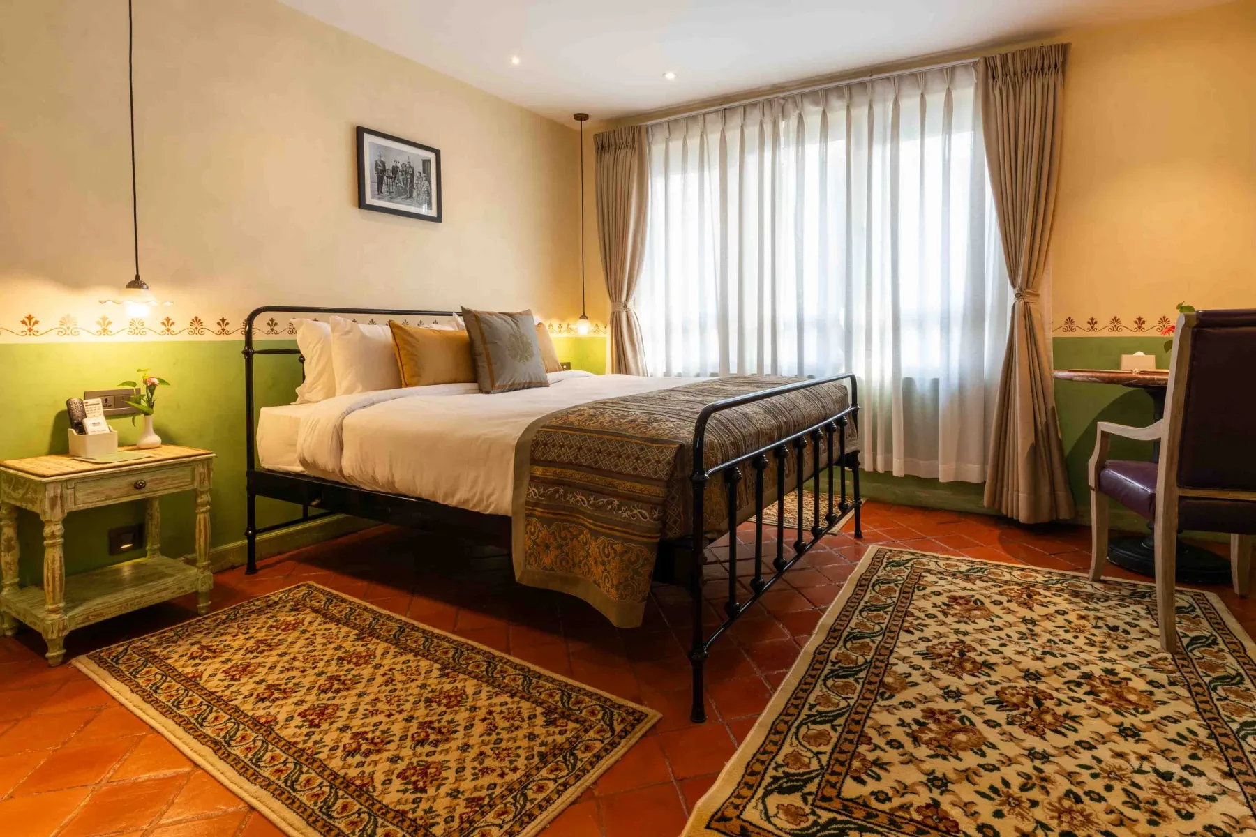 Classic Deluxe Room in the Neo-Classical Wing with a wrought-iron double bed.