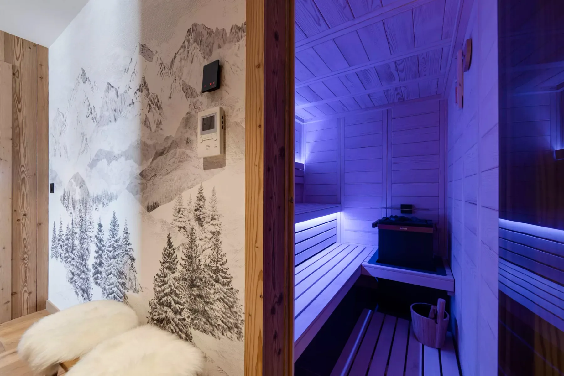 A sauna room with wooden benches and blue accent lighting.