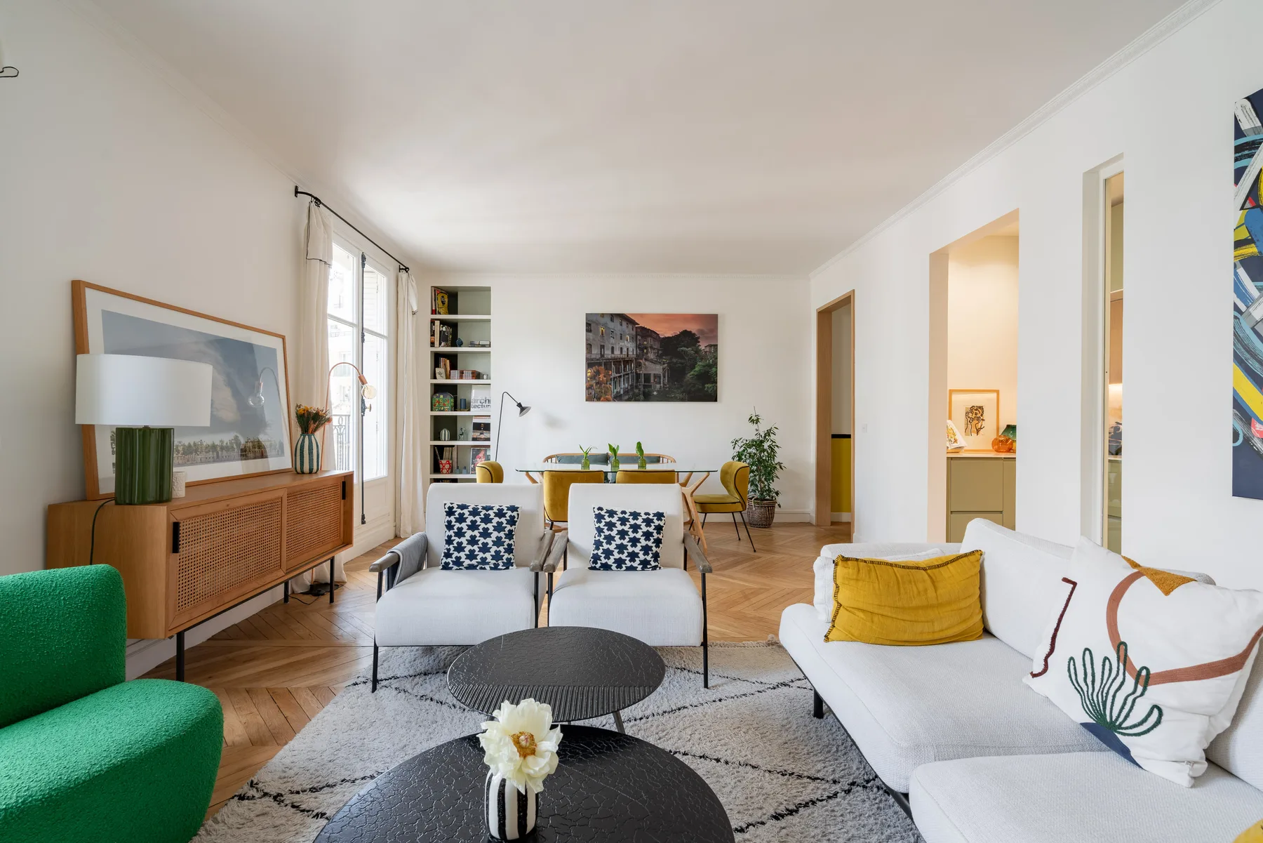 A bright living room with seating arranged around a low coffee table.