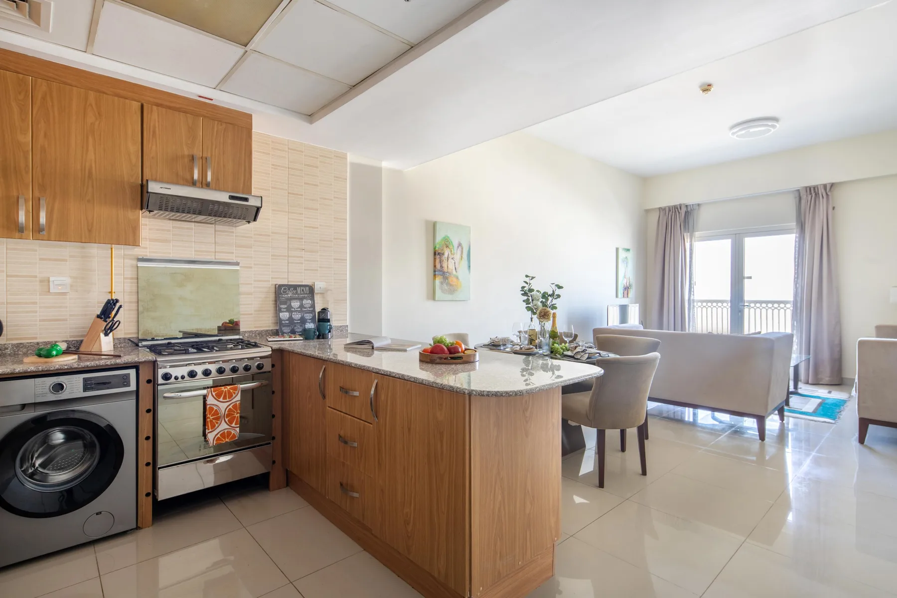 An open-plan kitchen and living area with a dining counter and seating.