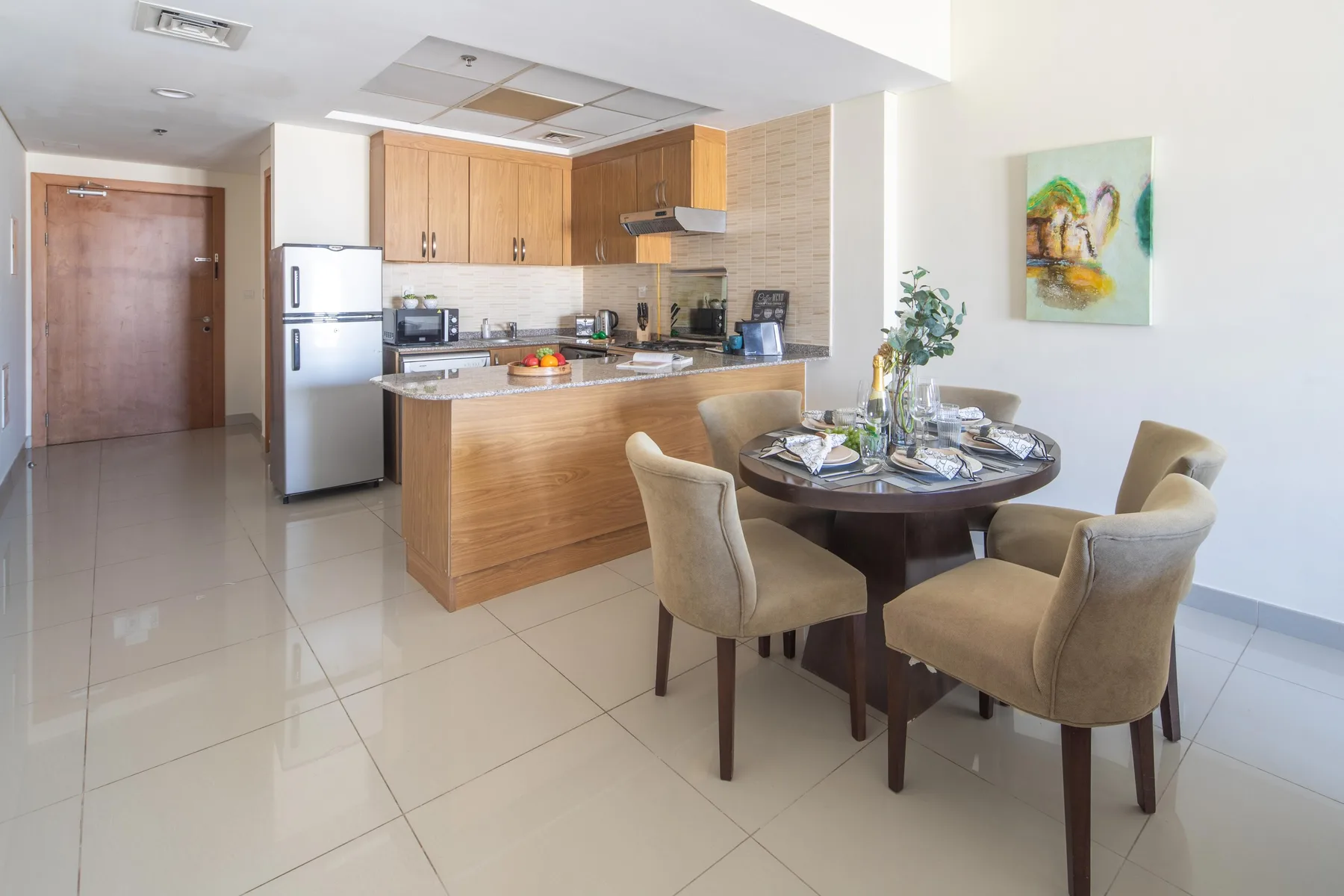 An open kitchen and dining area with a counter and a round dining table.