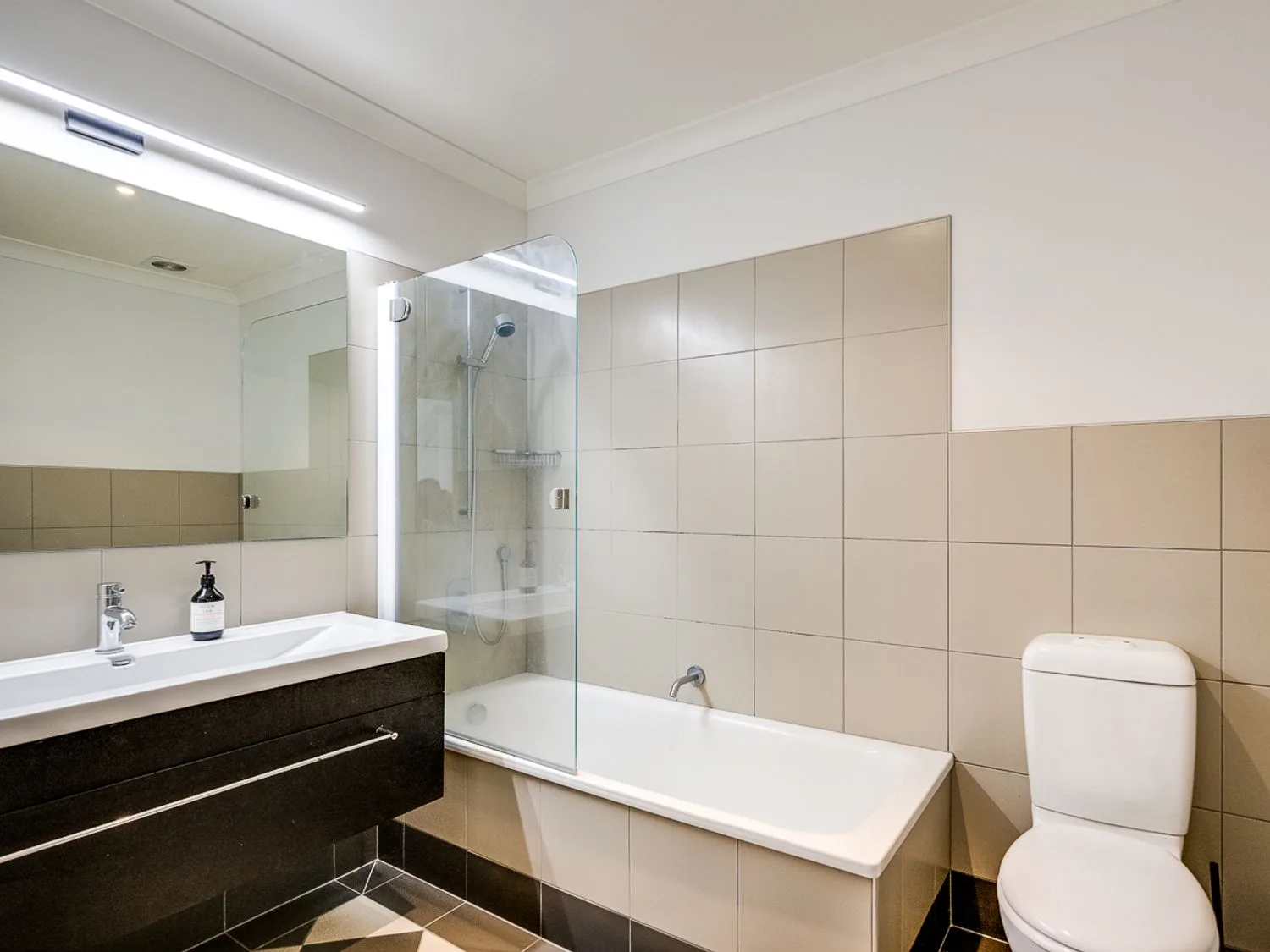 A bathroom with a bathtub, shower, sink, and toilet.