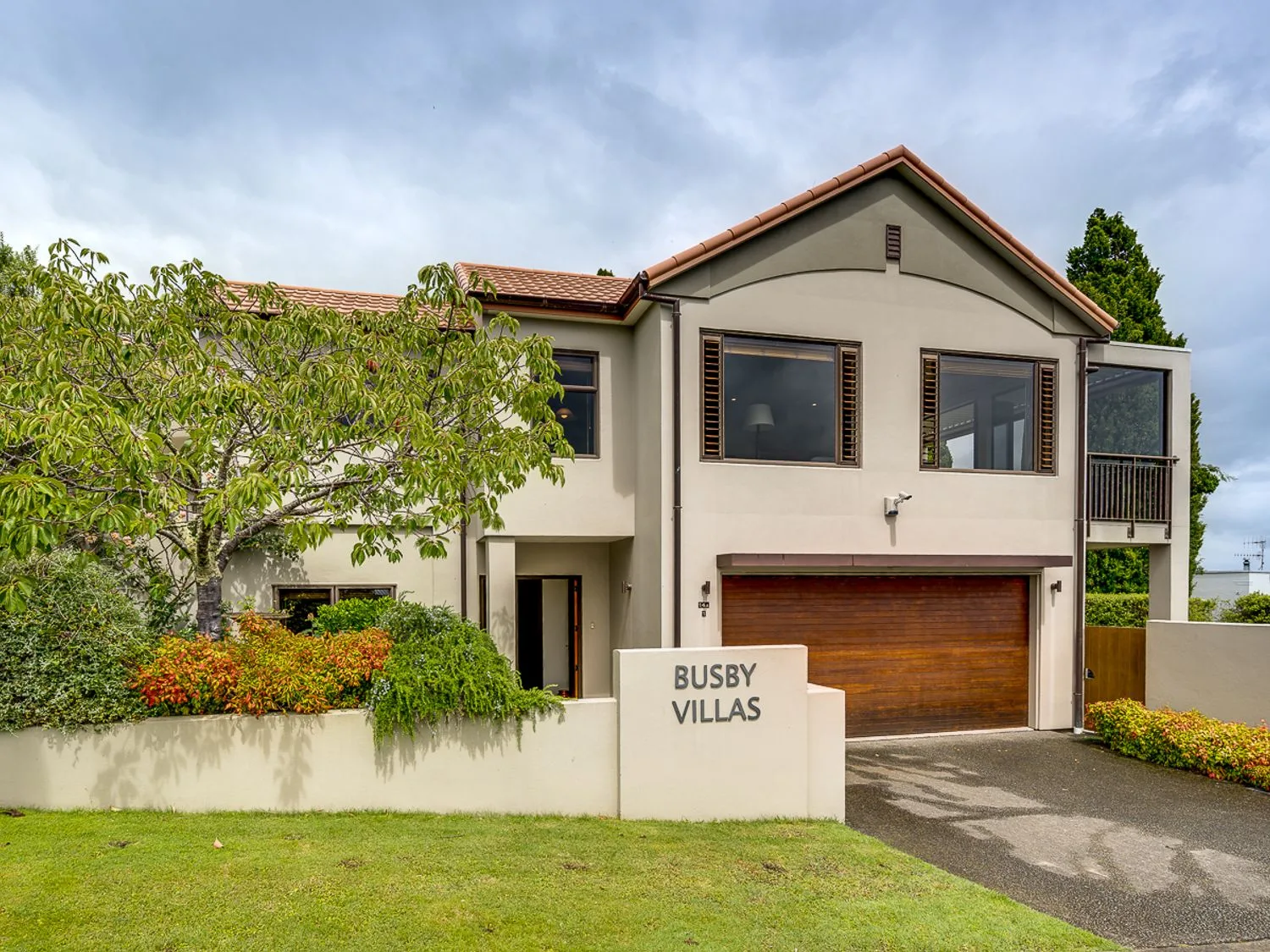 A modern house with a garage and front garden.