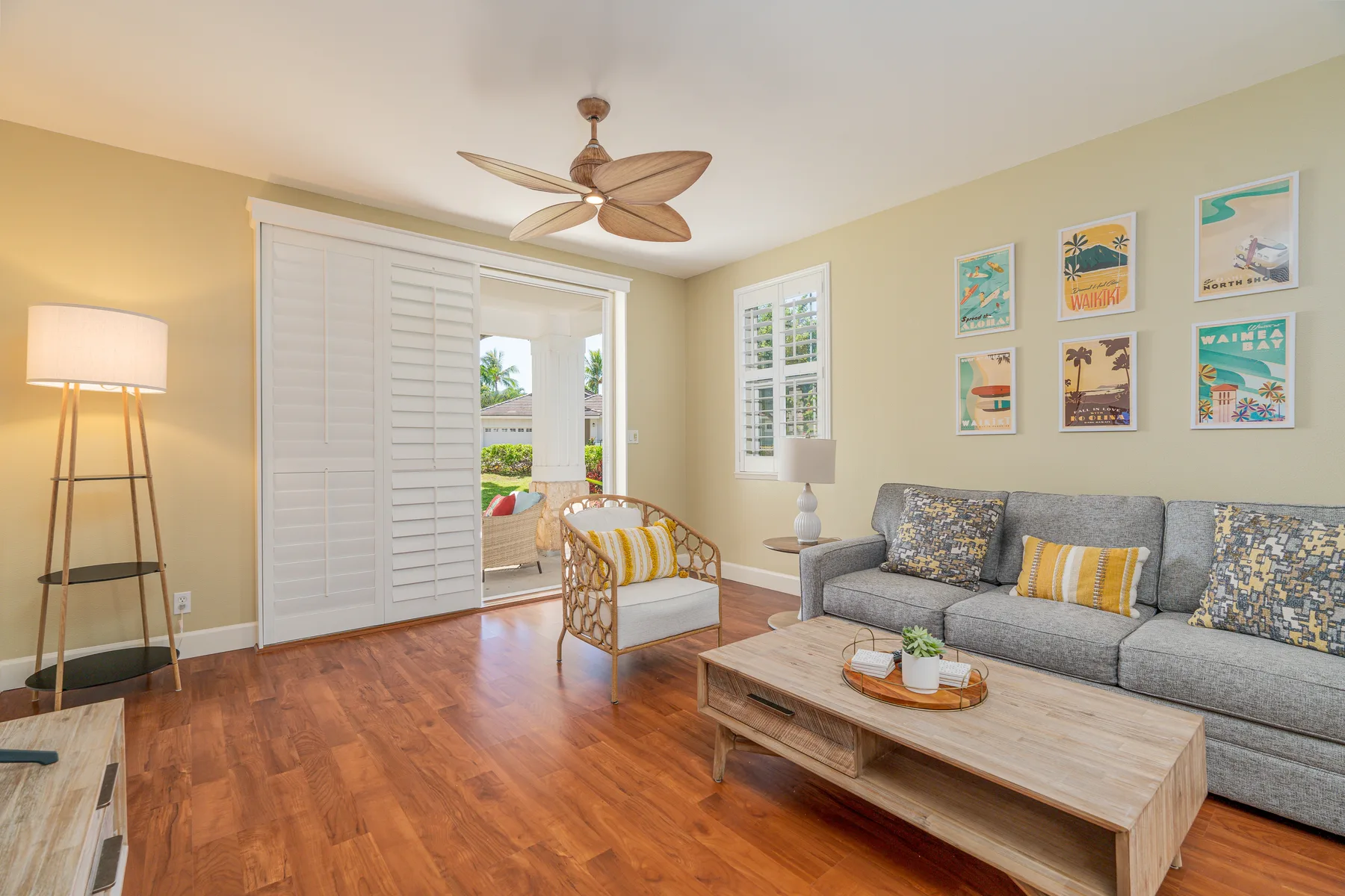 A bright living room with a gray sofa and a wooden coffee table.