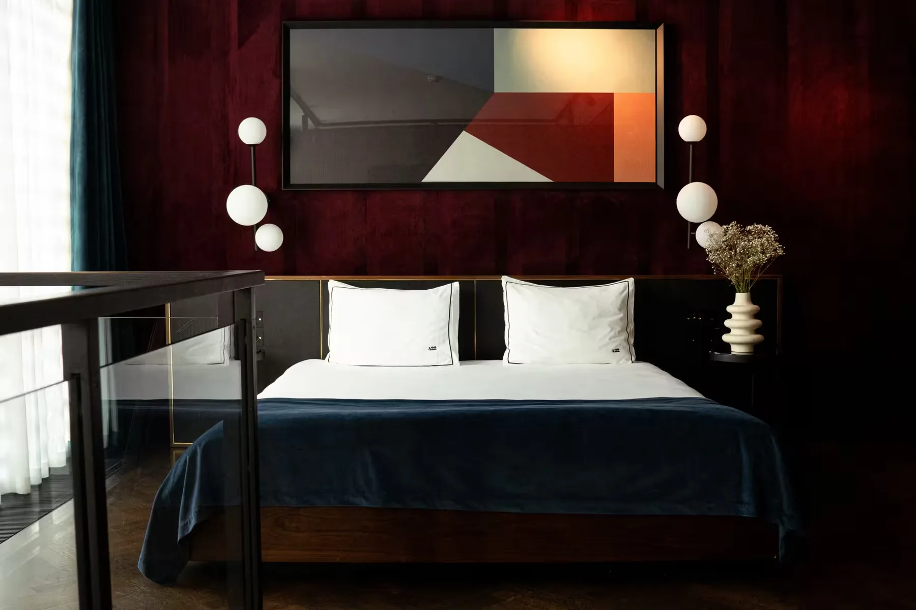 First Lady Suite JBK with king bed beneath abstract artwork