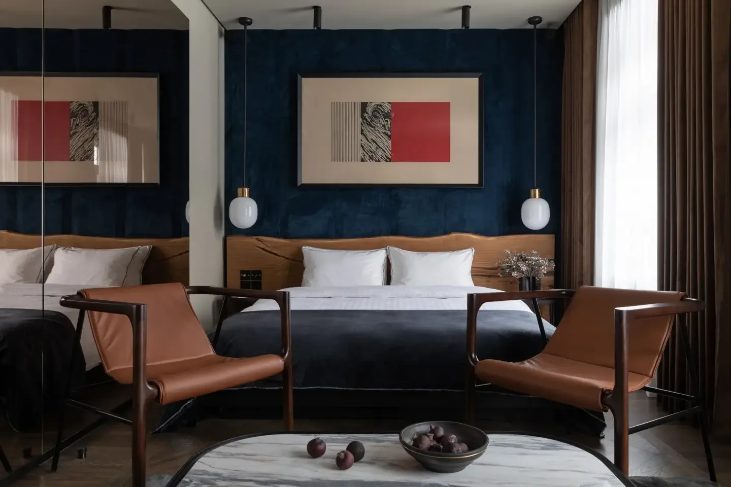 Superior Room with navy velvet wall and cognac leather chairs