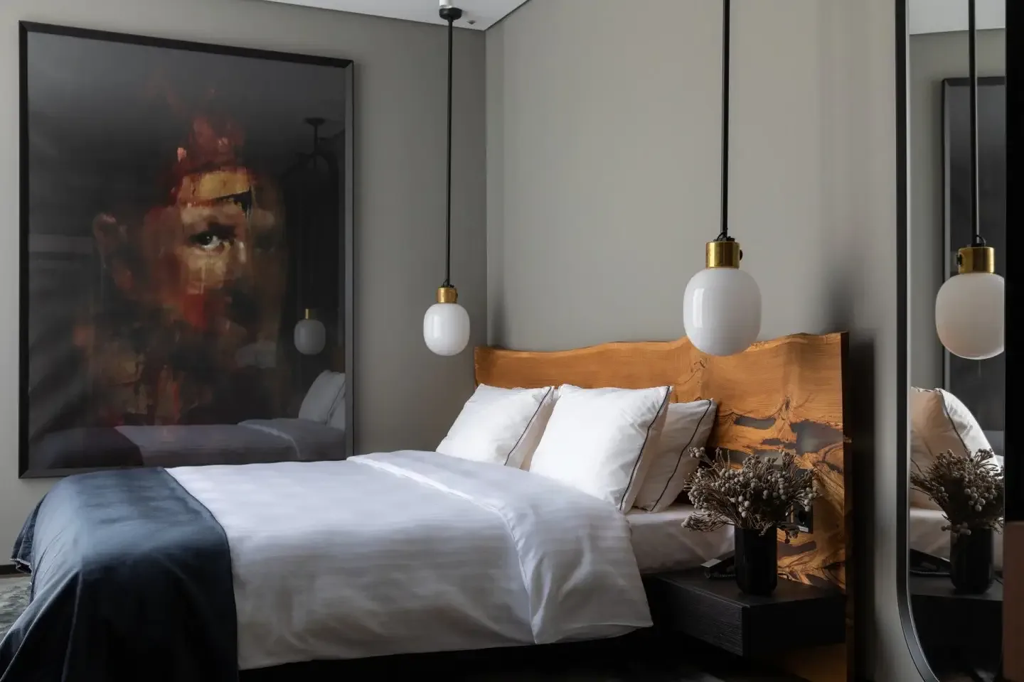 One Bedroom Suite with tan leather headboard and abstract artwork