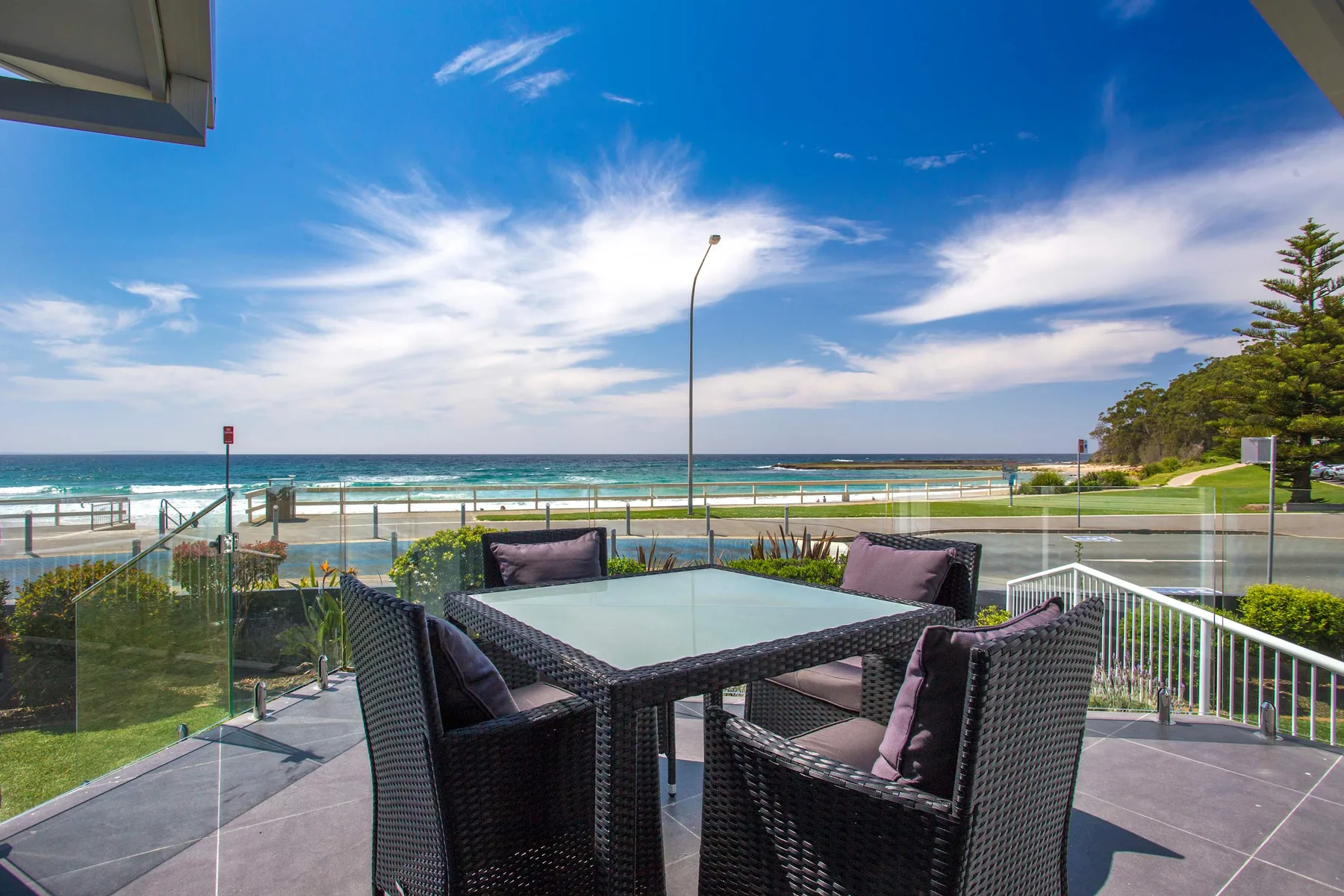 Outdoor patio seating overlooks the beach and ocean.