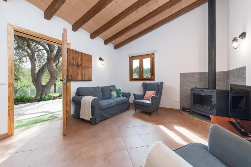 A living room with seating and a wood-beamed ceiling.