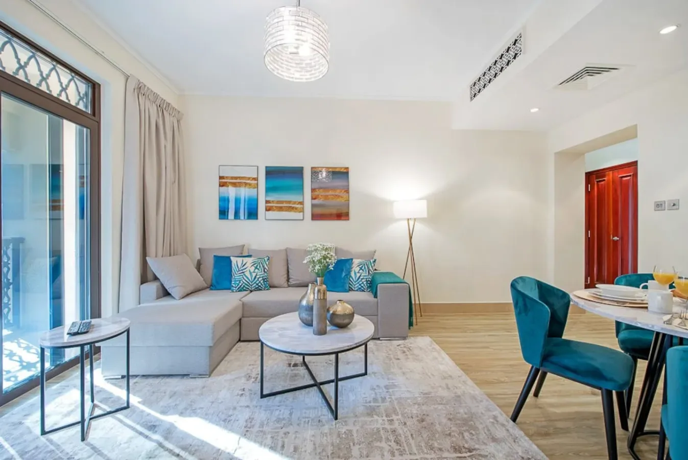 A bright living room with a sectional seating area and a round coffee table.