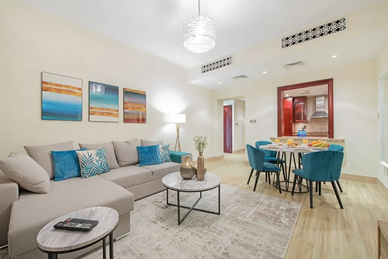 A bright living and dining area with seating around a coffee table and dining table.