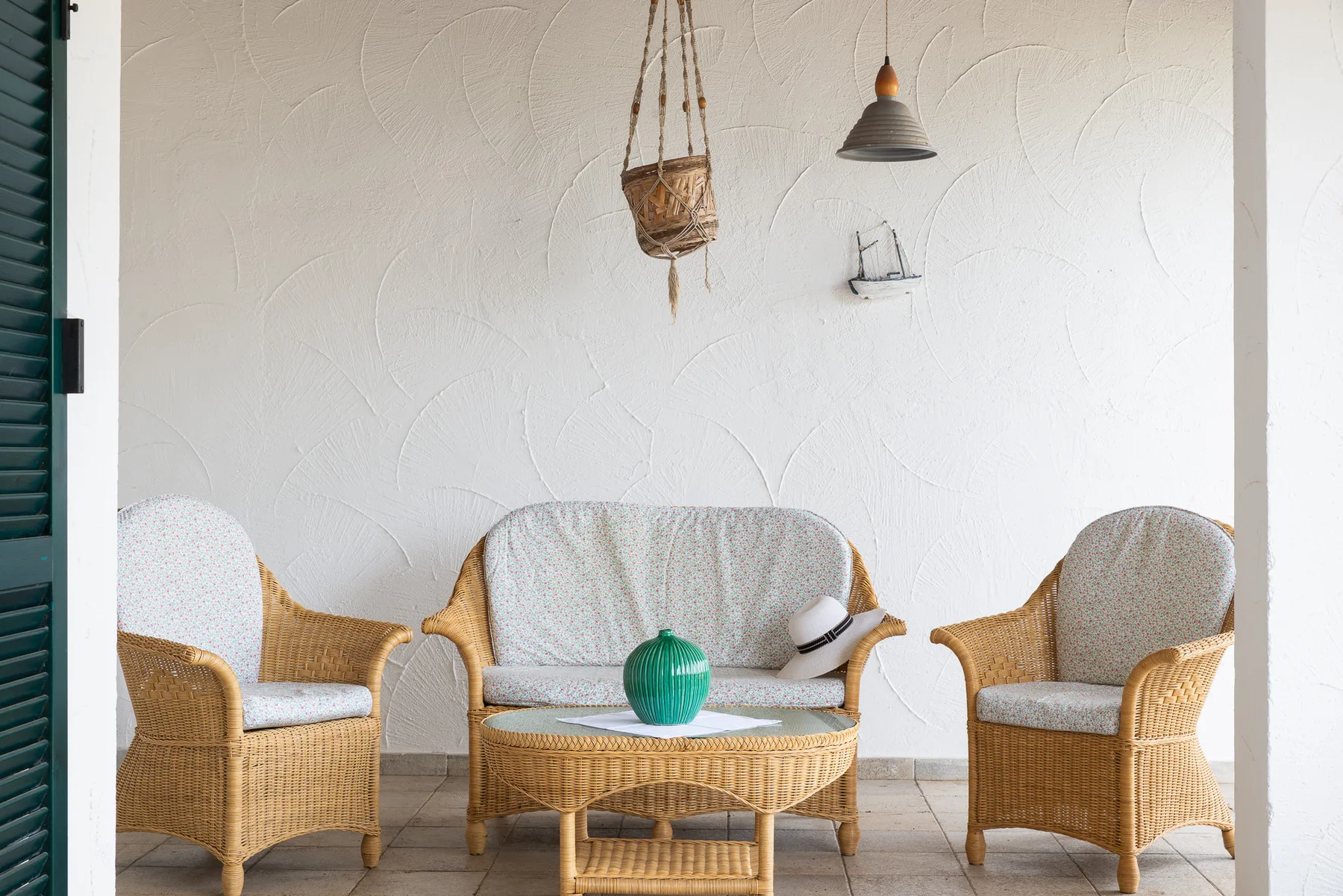 A bright sitting area with wicker seating and a small table.