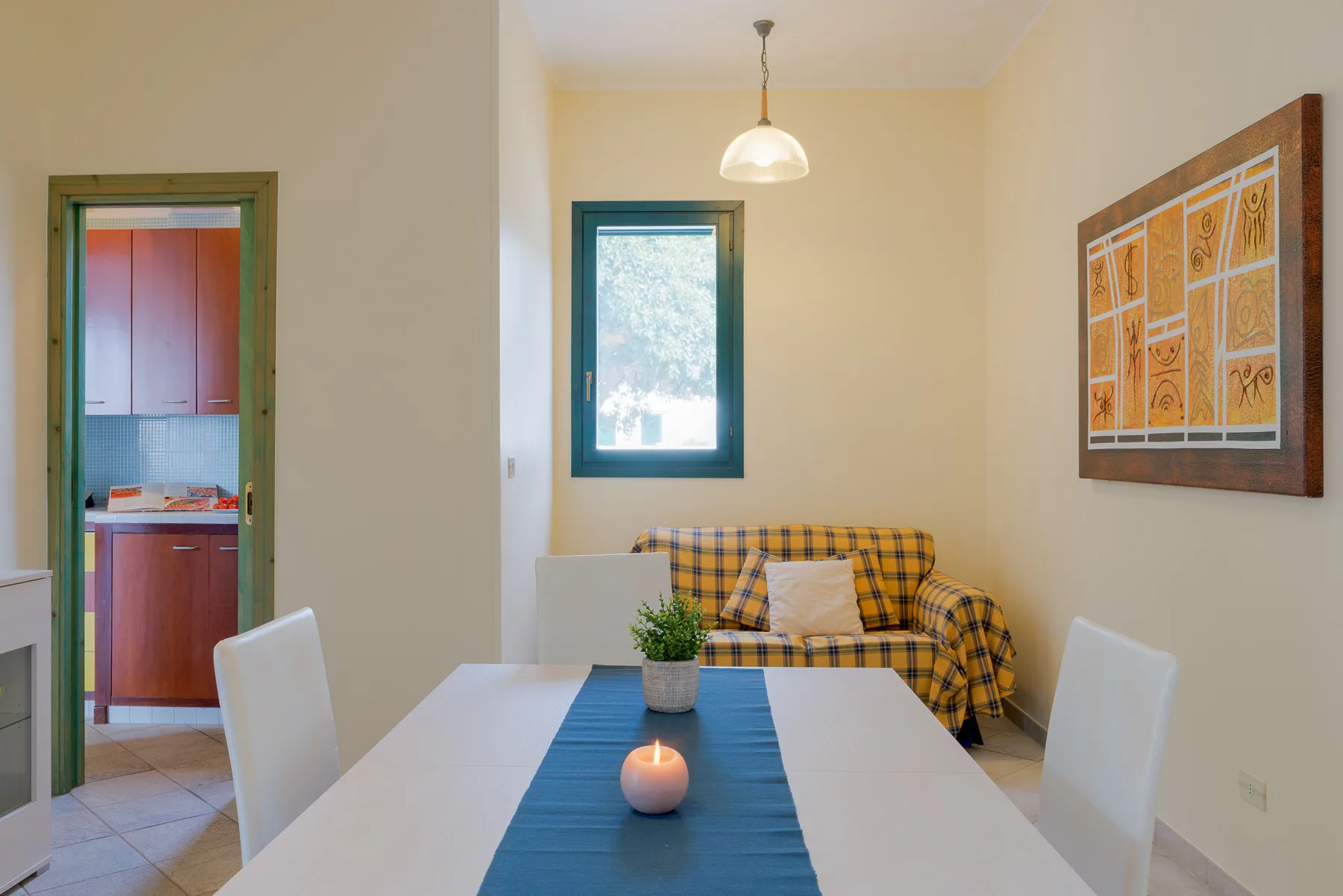 A dining area with a table, chairs, and a small seating nook.