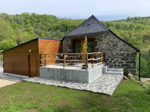 Stone guesthouse with a timber extension and terrace.