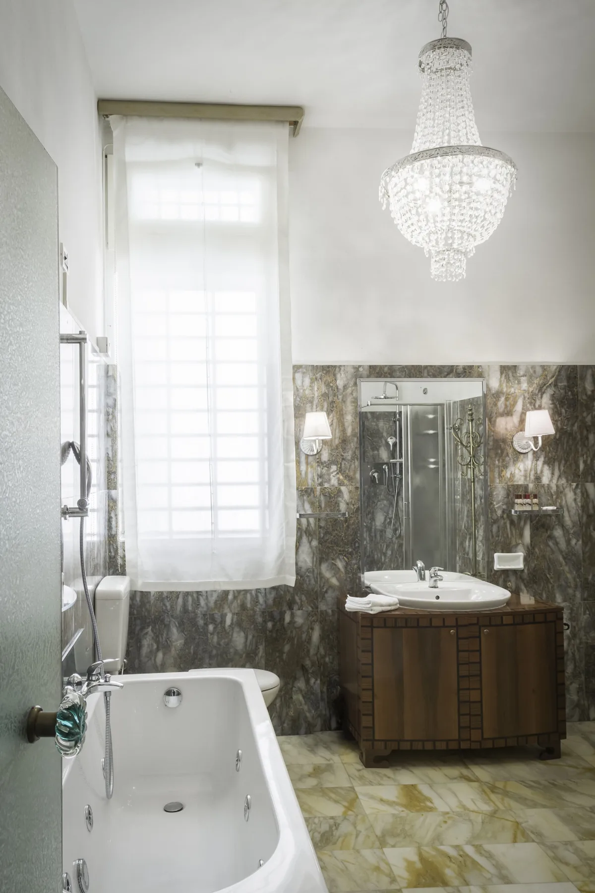 A bathroom with a bathtub, vanity, and large window.