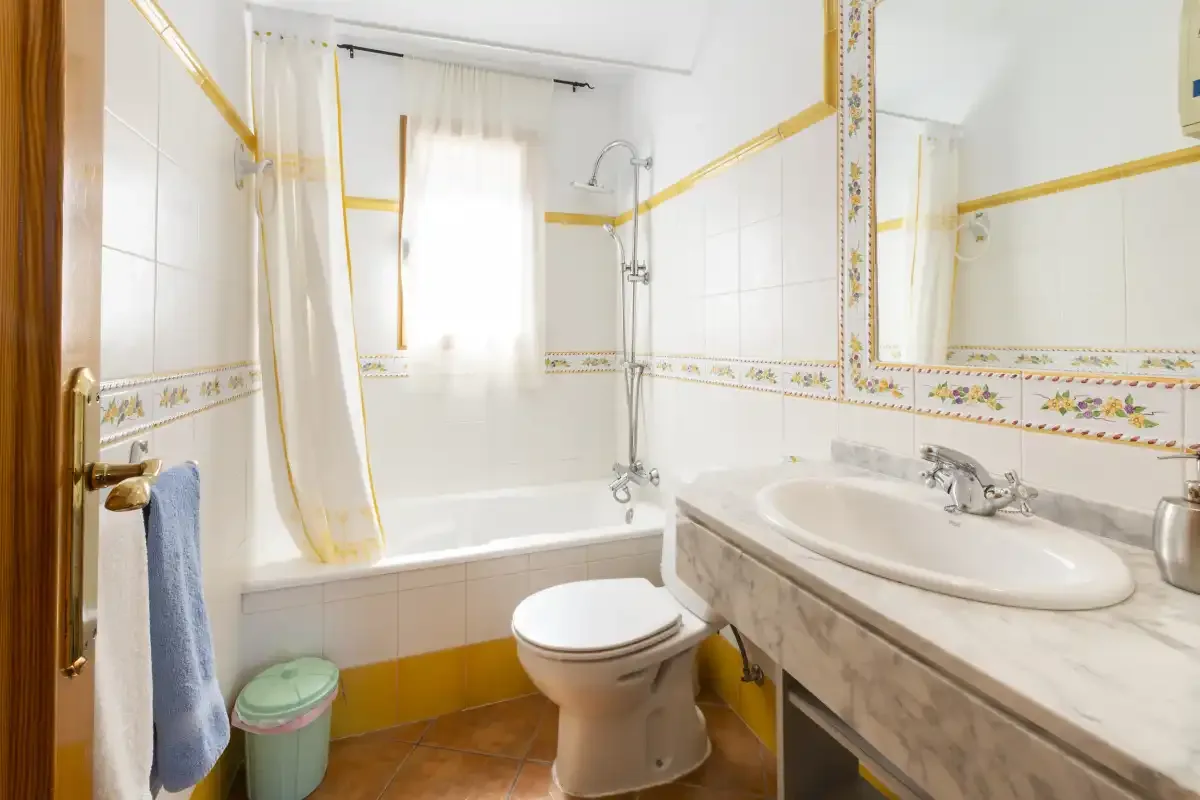 A bathroom with a bathtub, shower, toilet, and sink.