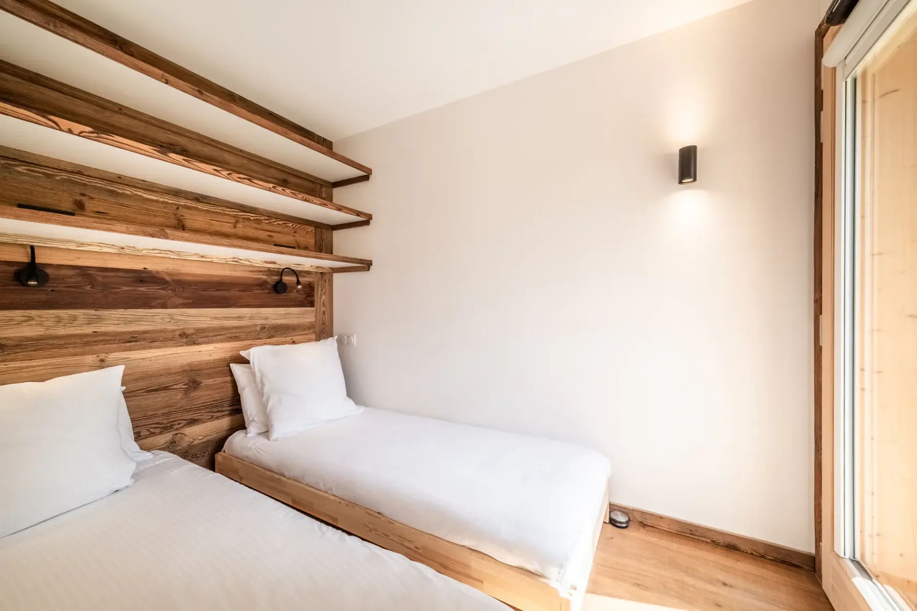 A bedroom with wooden walls and a wooden bed.
