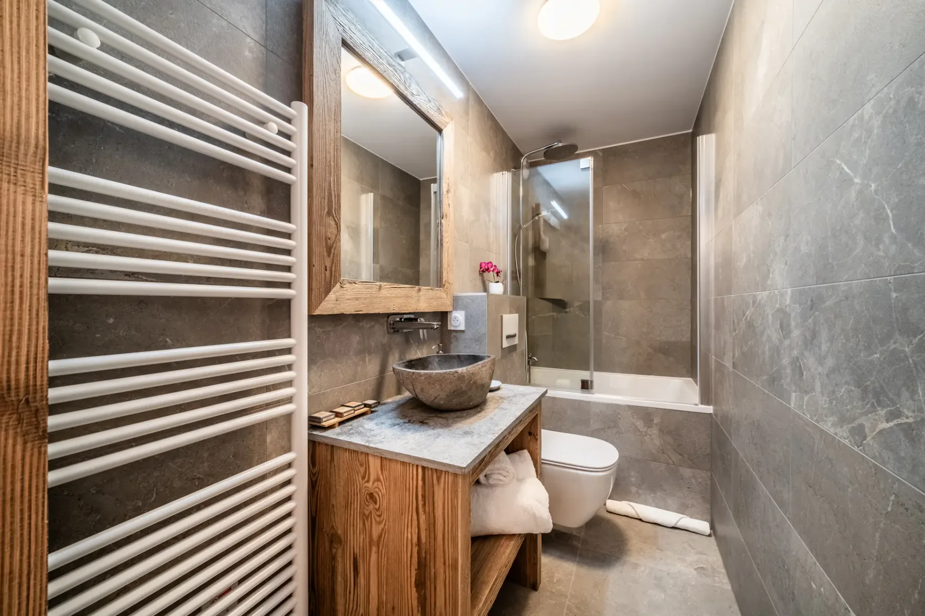 A bathroom with a sink, toilet, and shower.