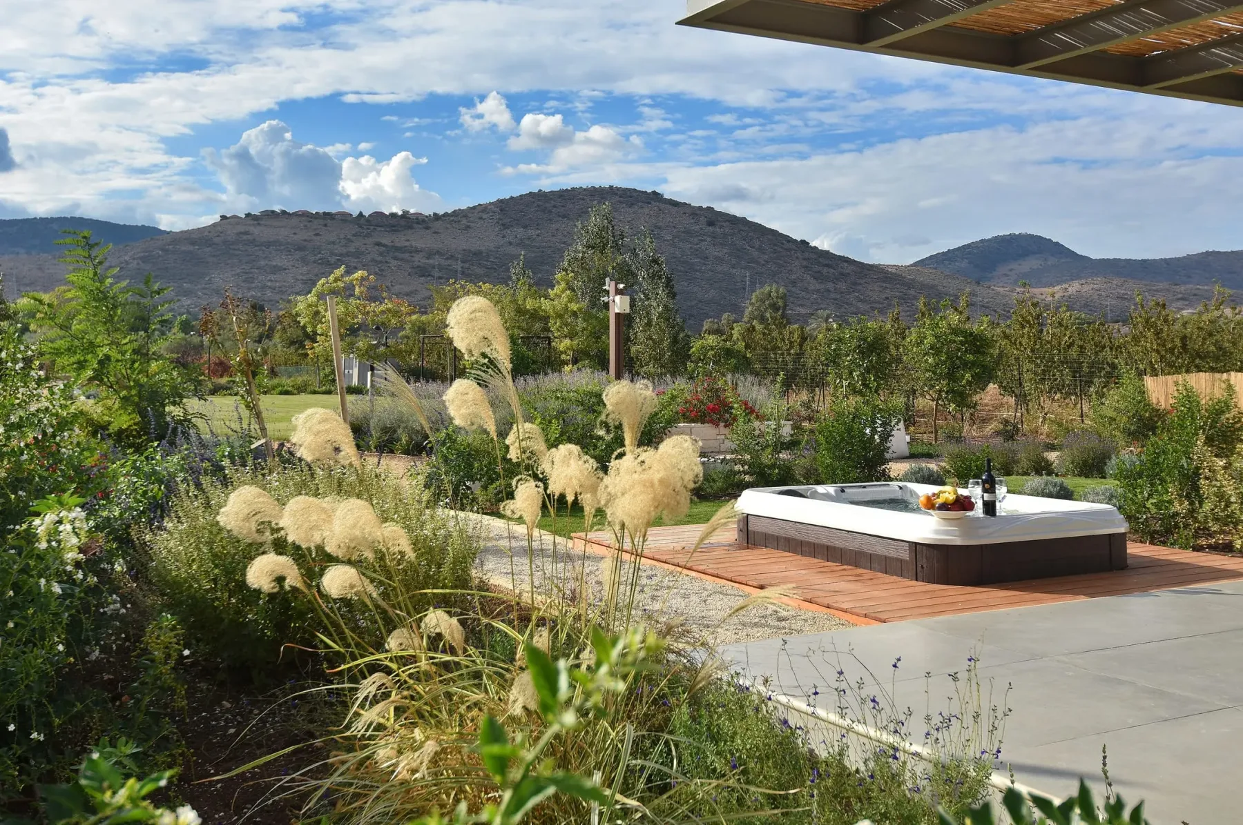 Outdoor jacuzzi on a garden deck overlooking the hills