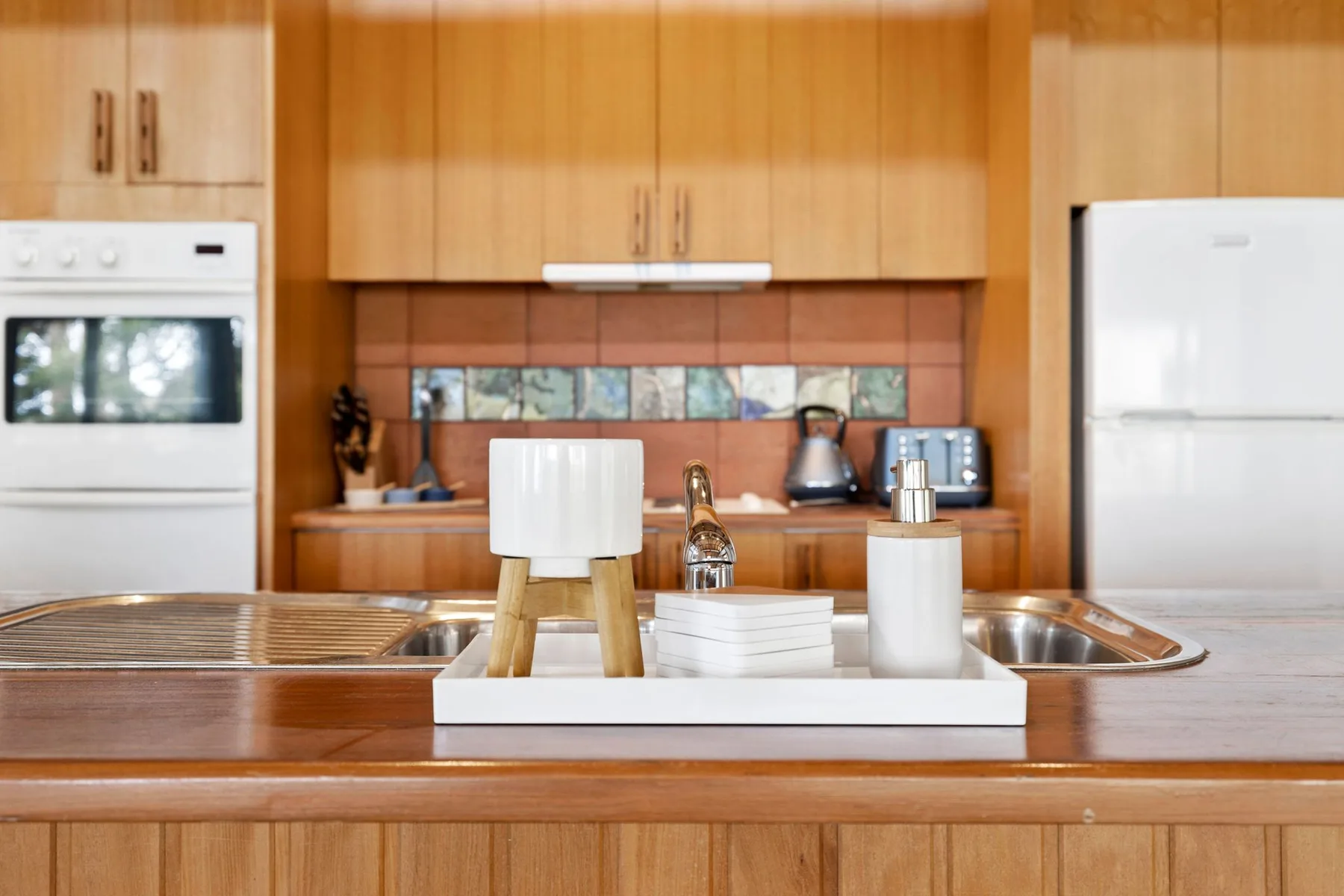 A kitchen with wooden cabinets, a countertop, and small appliances.