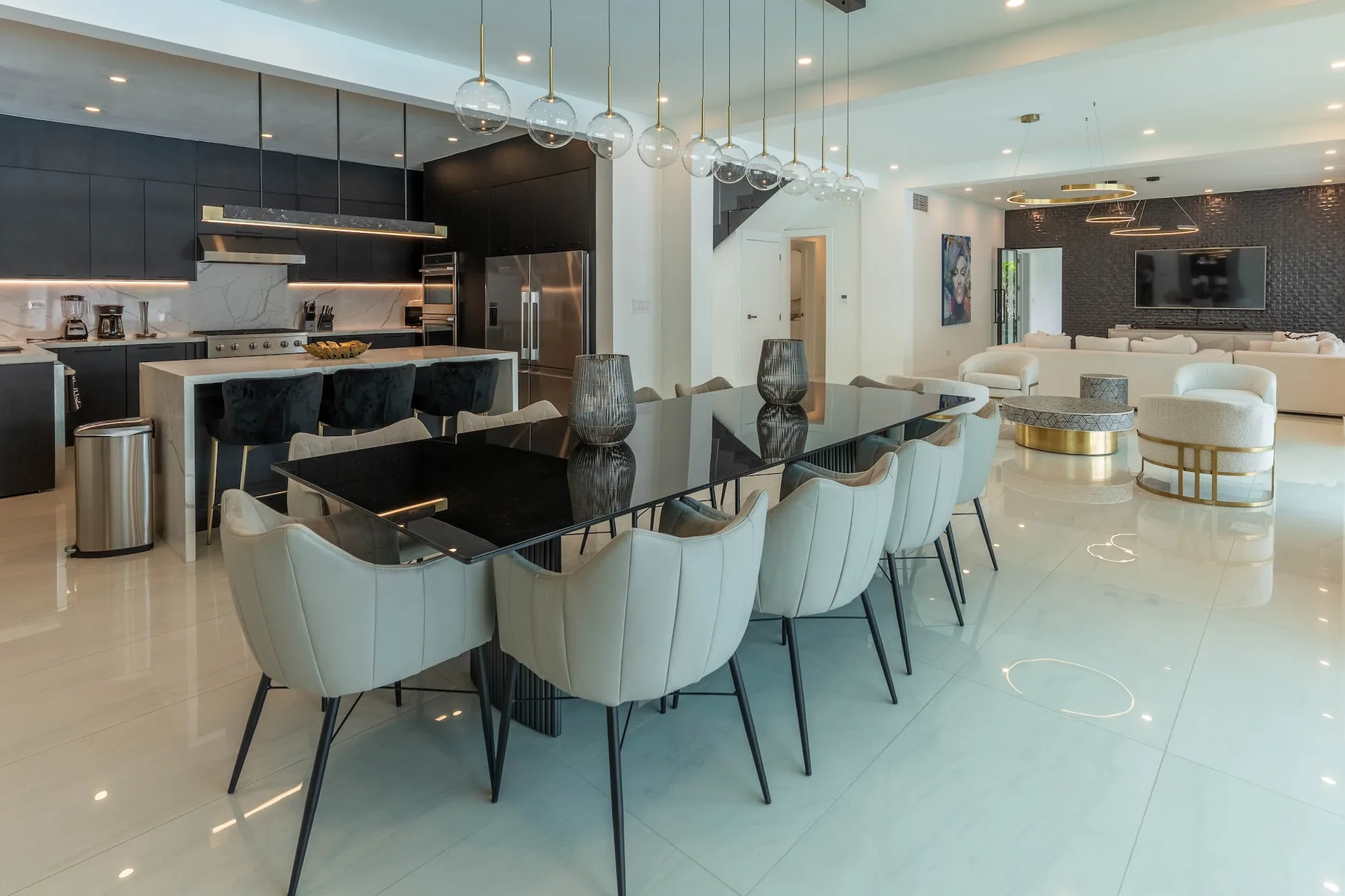 Comedor y sala de estar diáfanos con una mesa larga y cocina.