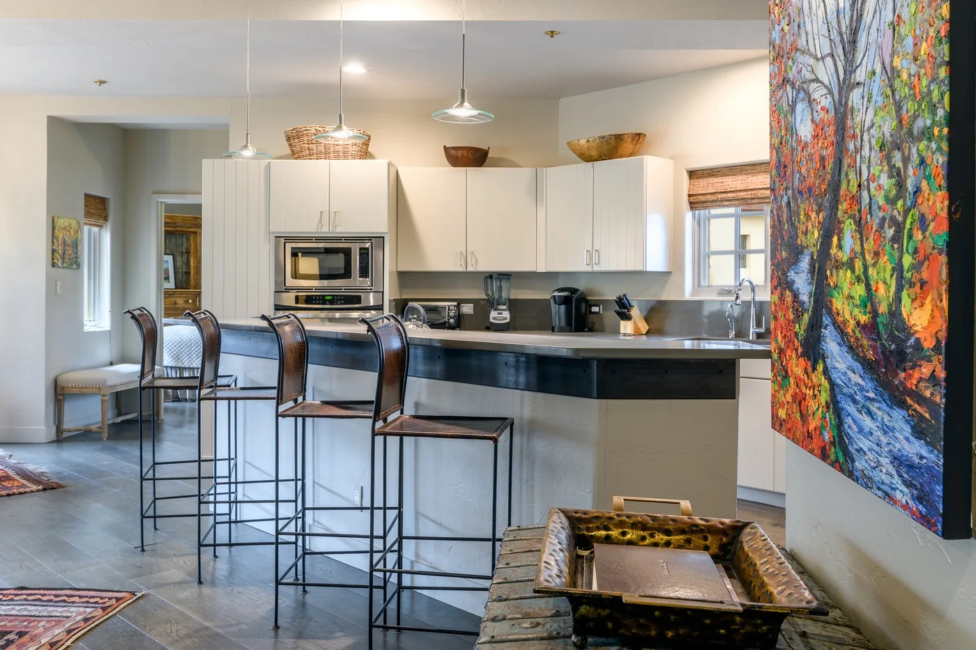 A bright kitchen with a central island and bar seating.