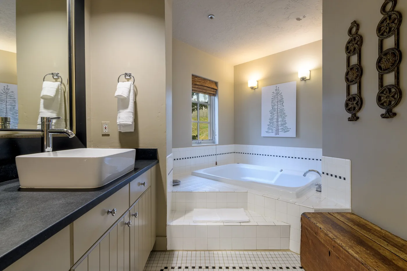 A bathroom with a bathtub, sink, and window.