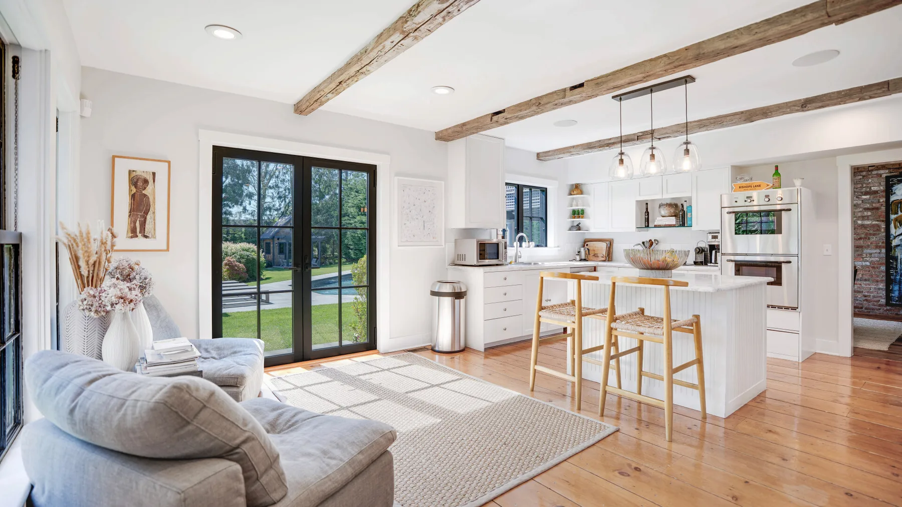 An open kitchen and living area with an island and seating.