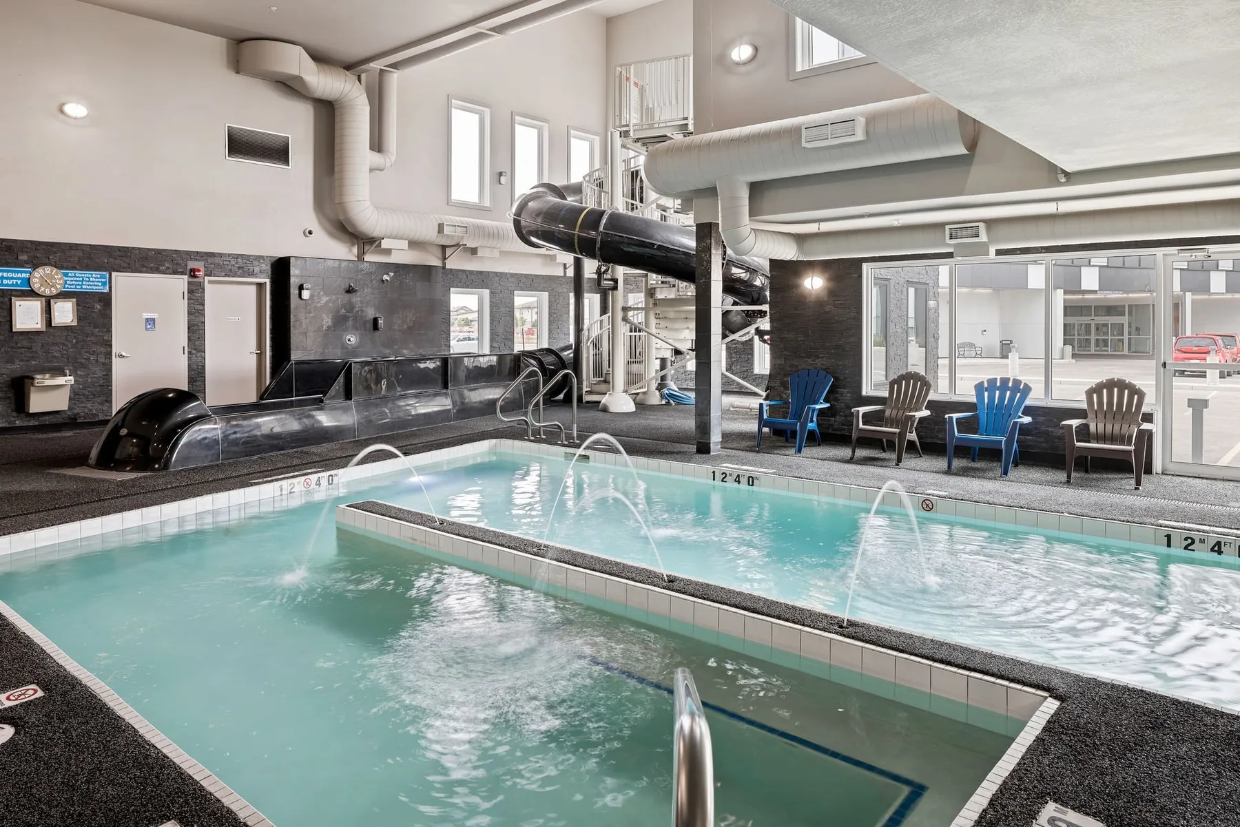 Indoor pool with slide and hot tub