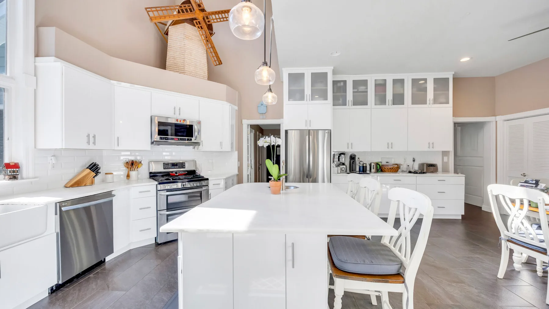 Una cocina luminosa con gabinetes blancos y una gran isla central.