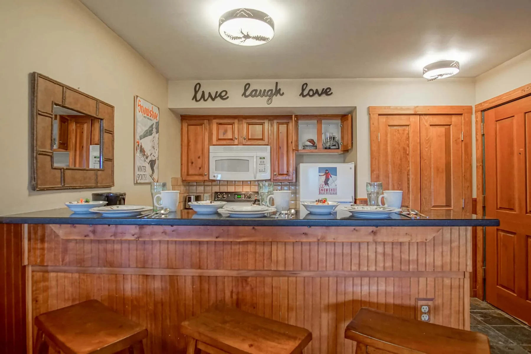 A wood-paneled kitchen counter faces wooden cabinets and appliances.