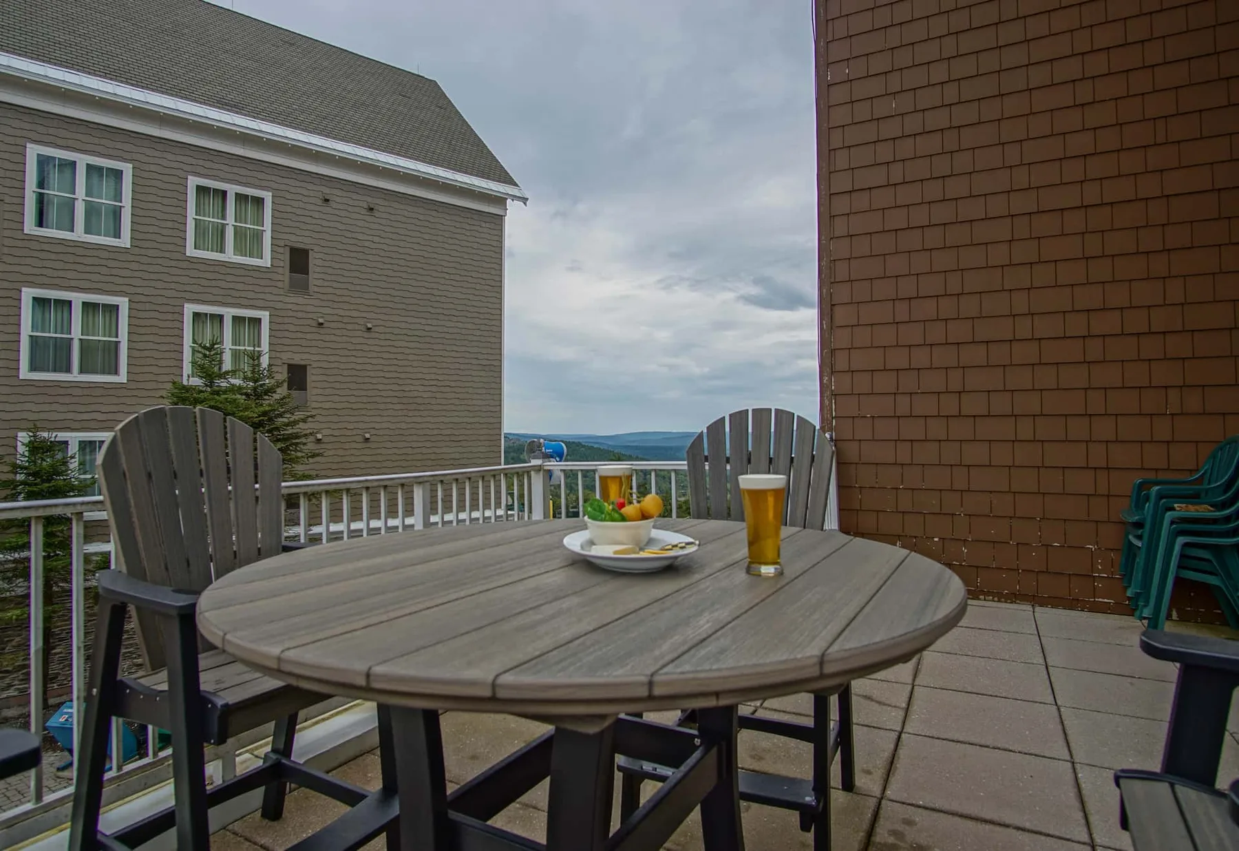A rooftop patio with outdoor seating and a view of the water.