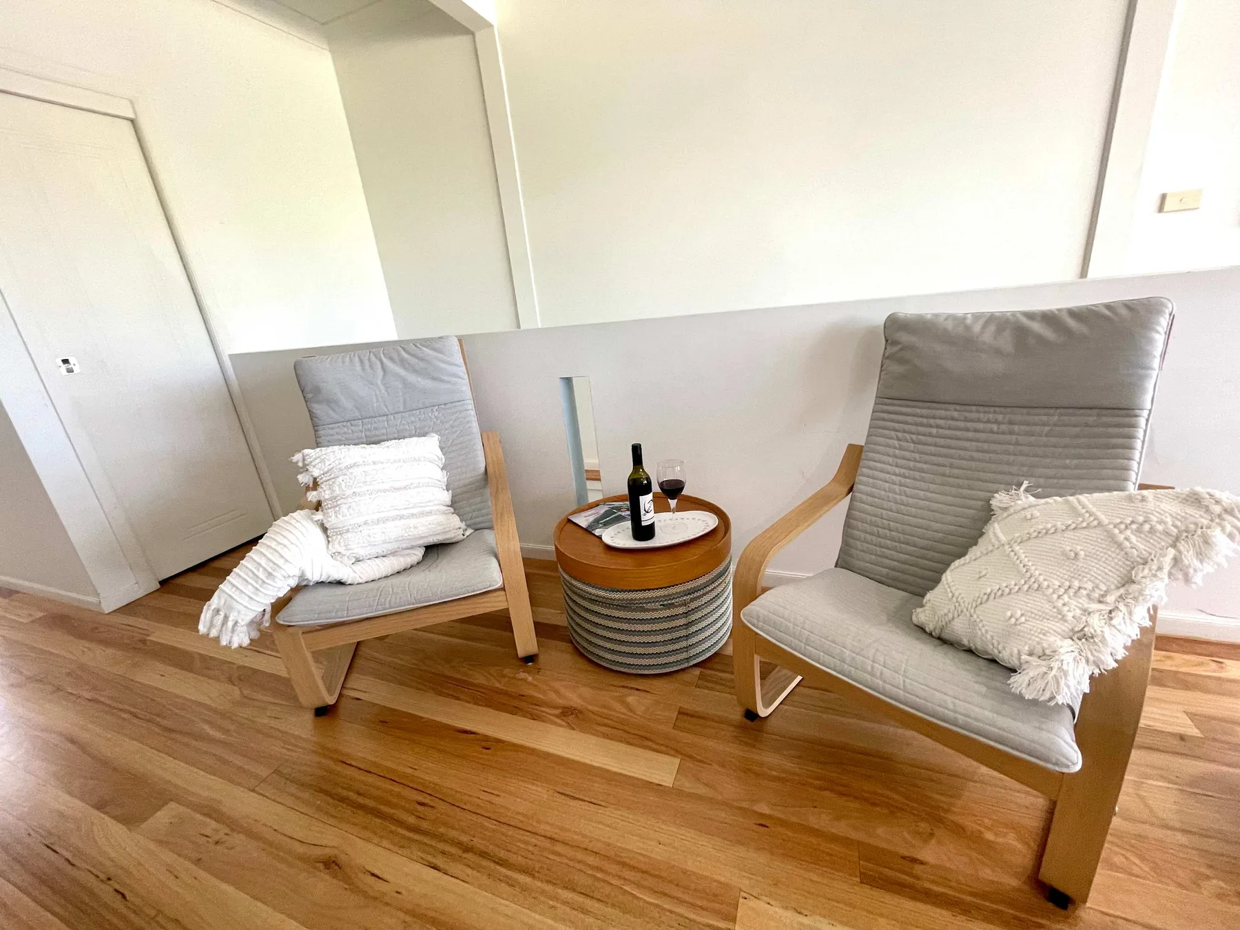 A bright sitting area with two chairs and a small round table.
